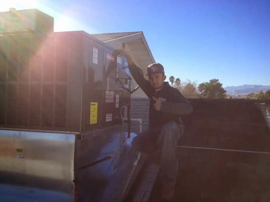 HVAC technician performing AC Tune-Up on a rooftop unit in East Nottingham